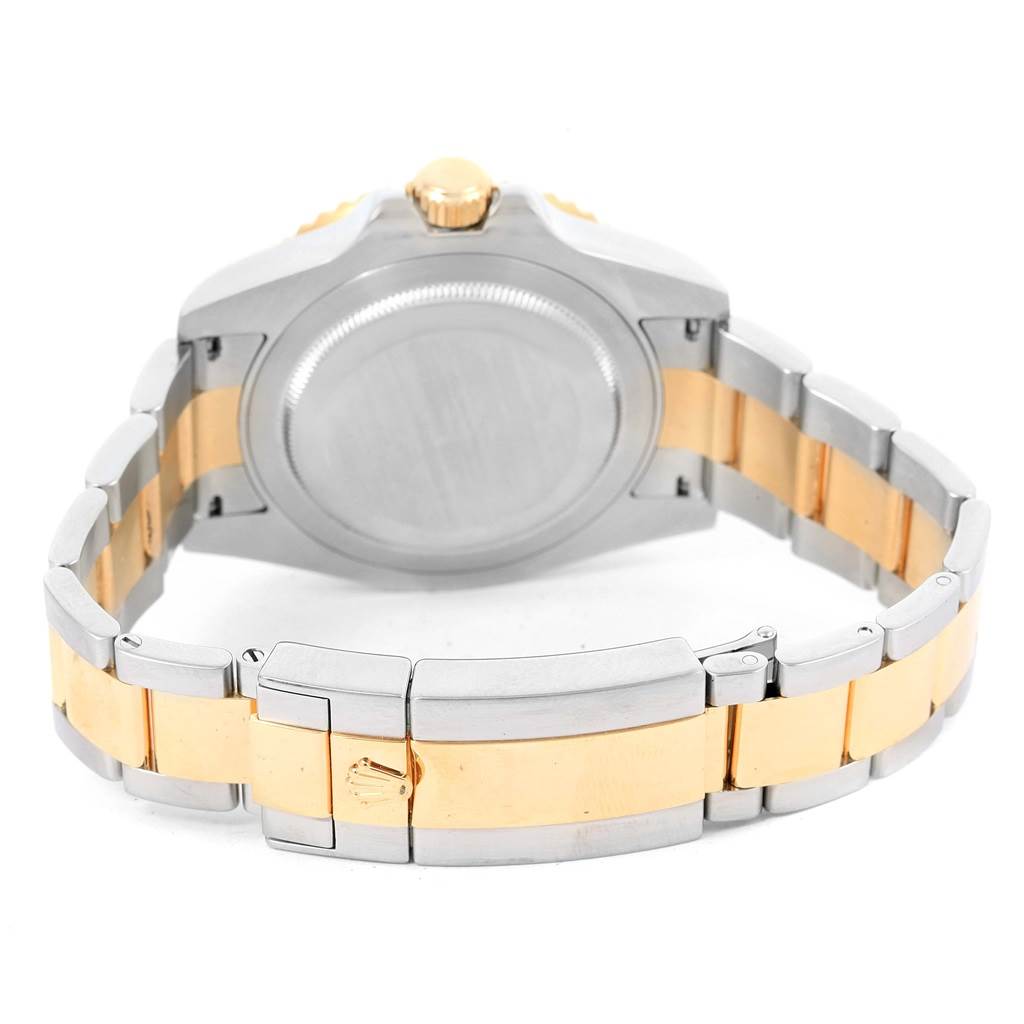 The image shows the back case and bracelet of a Rolex GMT-Master 116713 Men's Stainless Steel Black Dial 116713 Men's Stainless Steel Black Dial watch, featuring a steel and gold two-tone design.