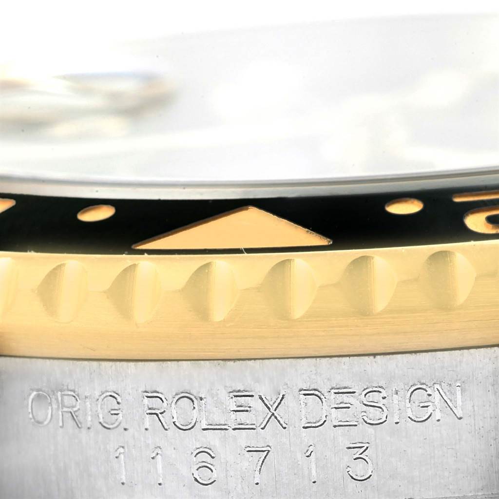The image shows a close-up of the bezel and case of a Rolex GMT-Master 116713 Men's Stainless Steel Black Dial 116713 Men's Stainless Steel Black Dial watch, revealing the model number and "Orig Rolex Design" engraving.