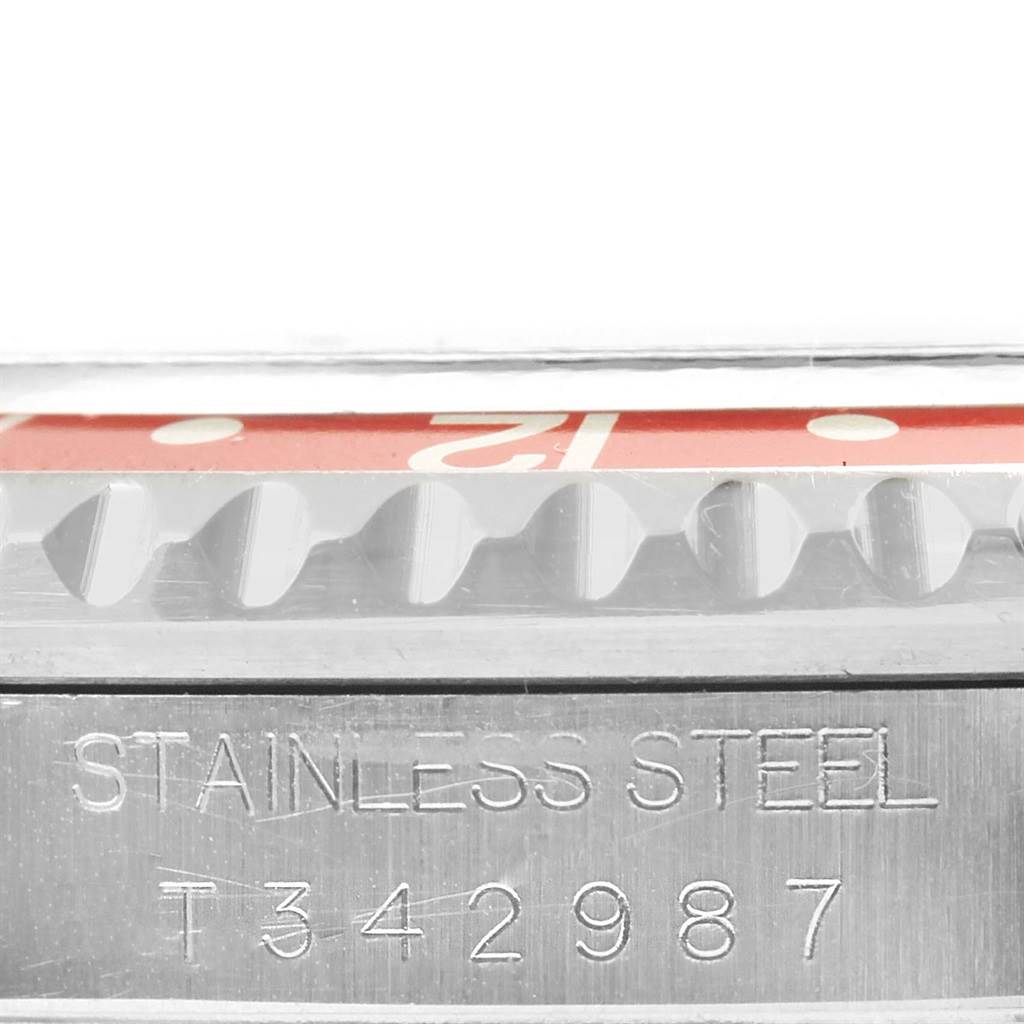 This image shows the side profile of a Rolex GMT-Master 16700 Men's Stainless Steel Black Dial 16700 Men's Stainless Steel Black Dial watch, highlighting the bezel and the stainless steel serial engraving.