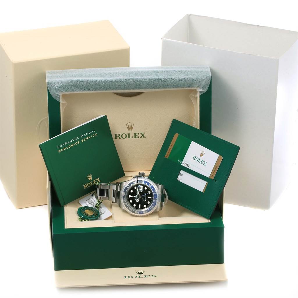The Rolex GMT-Master 116710 Men's Stainless Steel Black Dial 116710 Men's Stainless Steel Black Dial watch is shown from the front in its box, along with the guarantee manual, service booklet, and authenticity card.