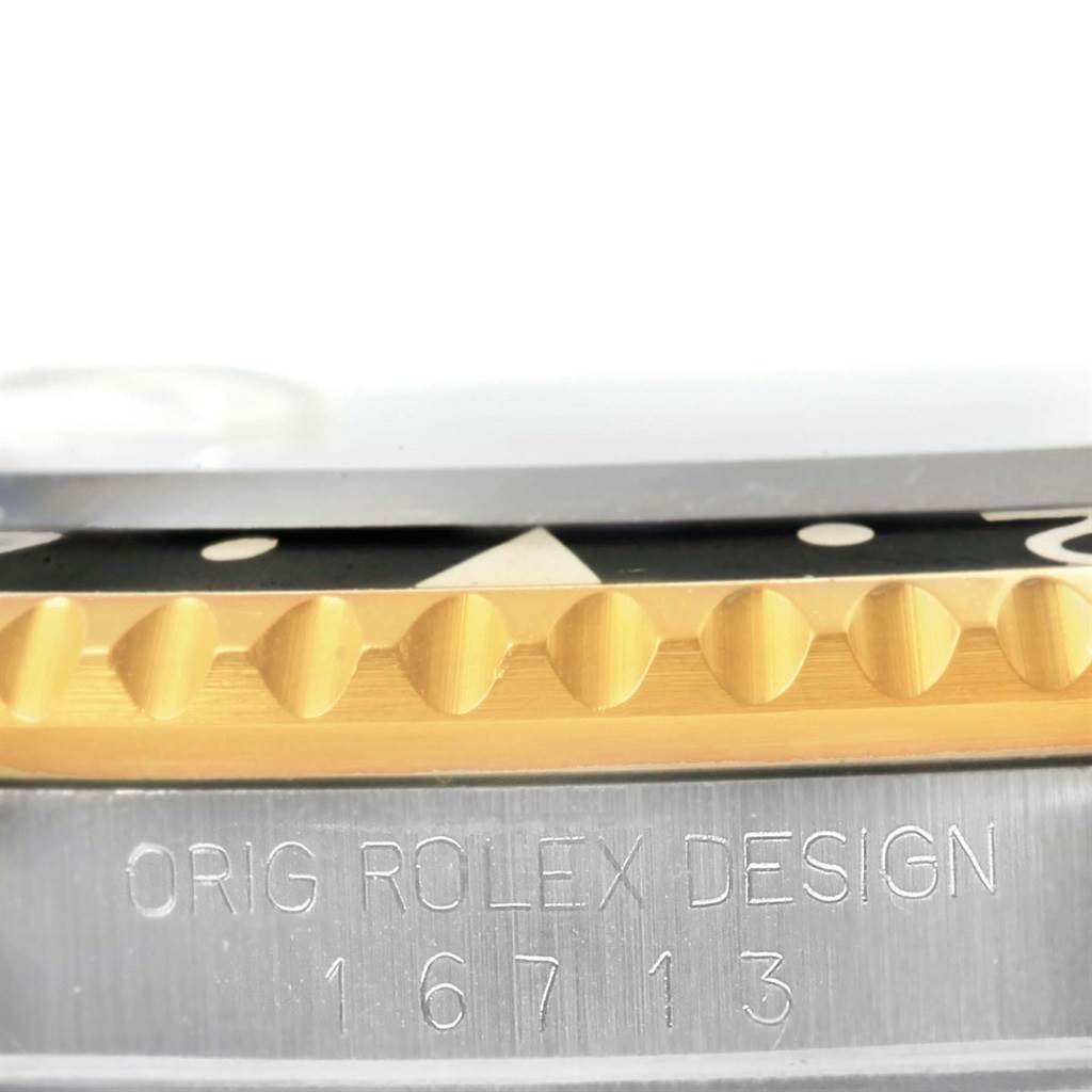The image shows a close-up side view of a Rolex GMT-Master 16713 Men's Stainless Steel Black Dial 16713 Men's Stainless Steel Black Dial watch, focusing on the bezel and the "ORIG ROLEX DESIGN 16713" engraving.