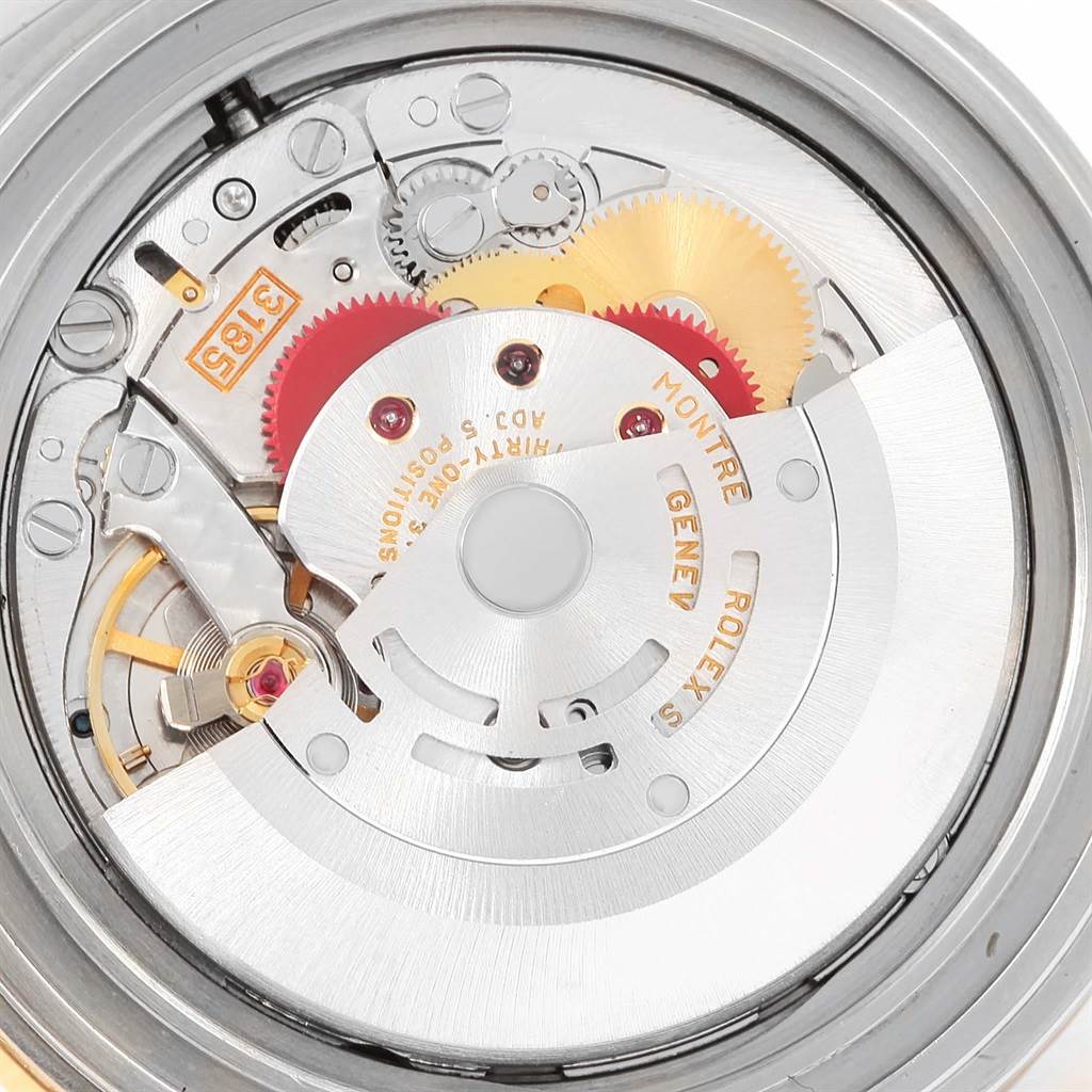 This is a close-up view of the movement components of a Rolex GMT-Master 16713 Men's Stainless Steel Black Dial 16713 Men's Stainless Steel Black Dial watch, showing gears, rotors, and inscriptions.