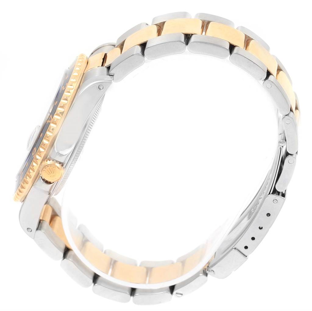 The image shows a side view of a Rolex GMT-Master 16713 Men's Stainless Steel Black Dial 16713 Men's Stainless Steel Black Dial watch, highlighting its two-tone bracelet and crown.