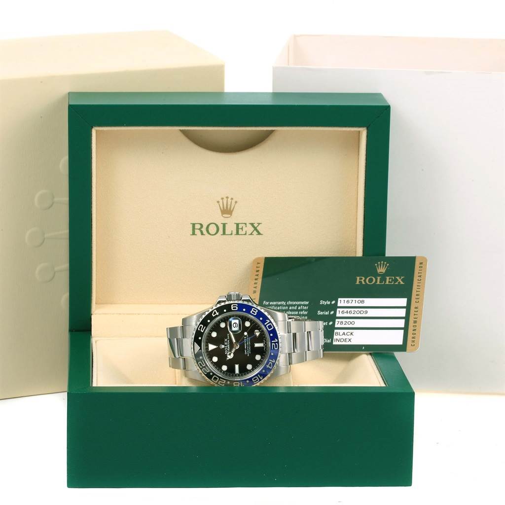 The Rolex GMT-Master 116710 Men's Stainless Steel Black Dial 116710 Men's Stainless Steel Black Dial watch is shown in its open box along with its certification card.