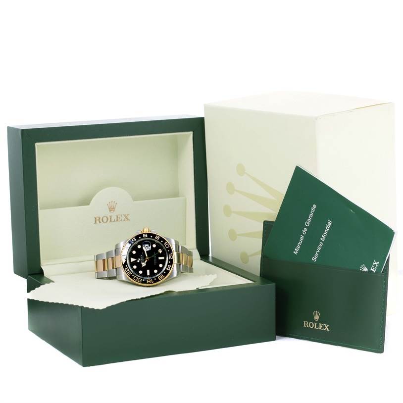 The Rolex GMT-Master 116713 Men's Stainless Steel Black Dial 116713 Men's Stainless Steel Black Dial watch is shown in its open box alongside the instruction manuals.