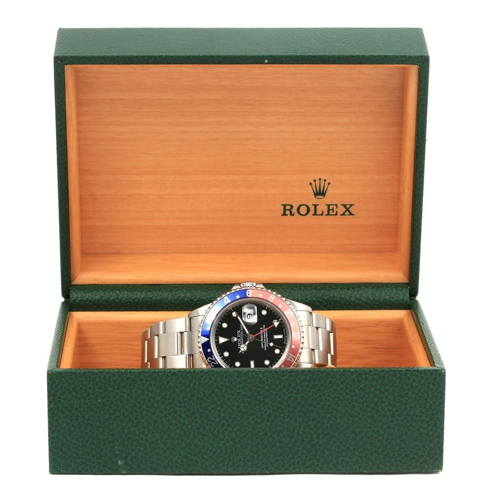 The Rolex GMT-Master 16710 Men's Stainless Steel Black Dial 16710 Men's Stainless Steel Black Dial watch is displayed front-on in its green box with the lid open.