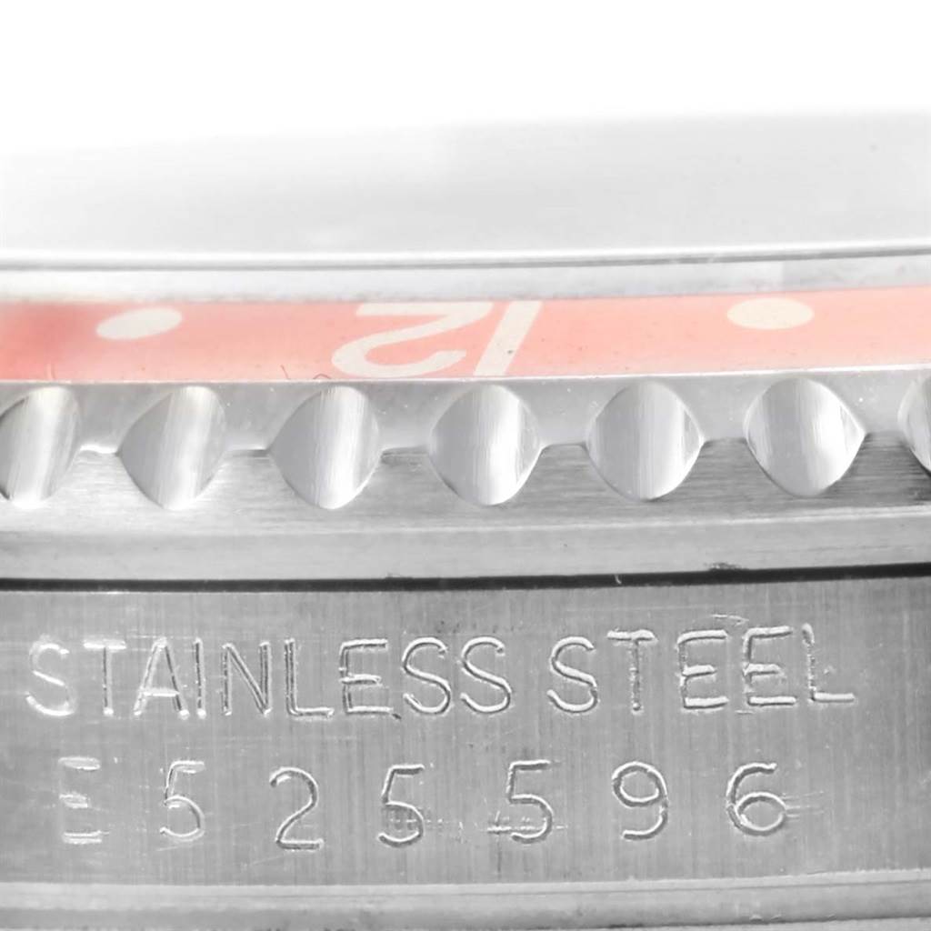 The image shows a close-up of the bezel and serial number on the stainless steel casing of a Rolex GMT-Master 16710 Men's Stainless Steel Black Dial 16710 Men's Stainless Steel Black Dial watch.