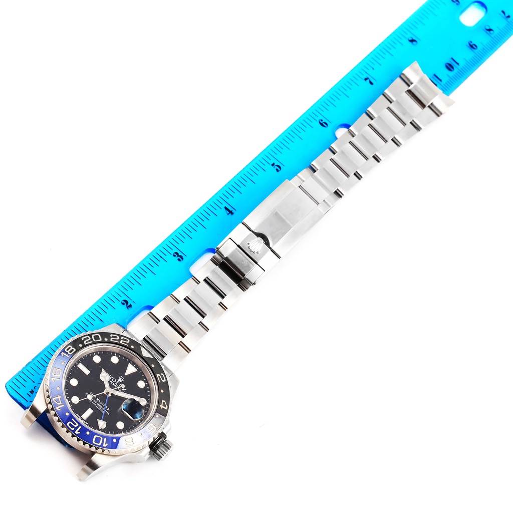 The image shows a Rolex GMT-Master 116710 Men's Stainless Steel Black Dial 116710 Men's Stainless Steel Black Dial watch laid flat with a ruler beside it, highlighting the watch face, bezel, and bracelet.