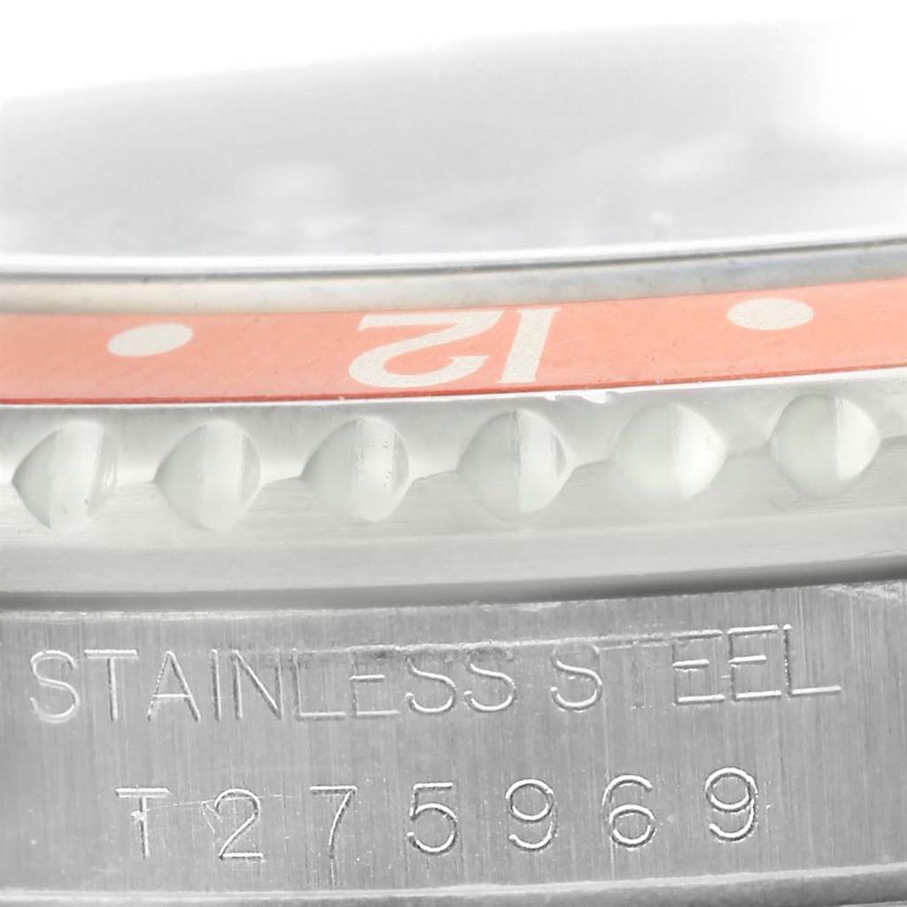 This close-up image of a Rolex GMT-Master 16700 Men's Stainless Steel Black Dial 16700 Men's Stainless Steel Black Dial shows the bezel and the "STAINLESS STEEL" engraving with its serial number.