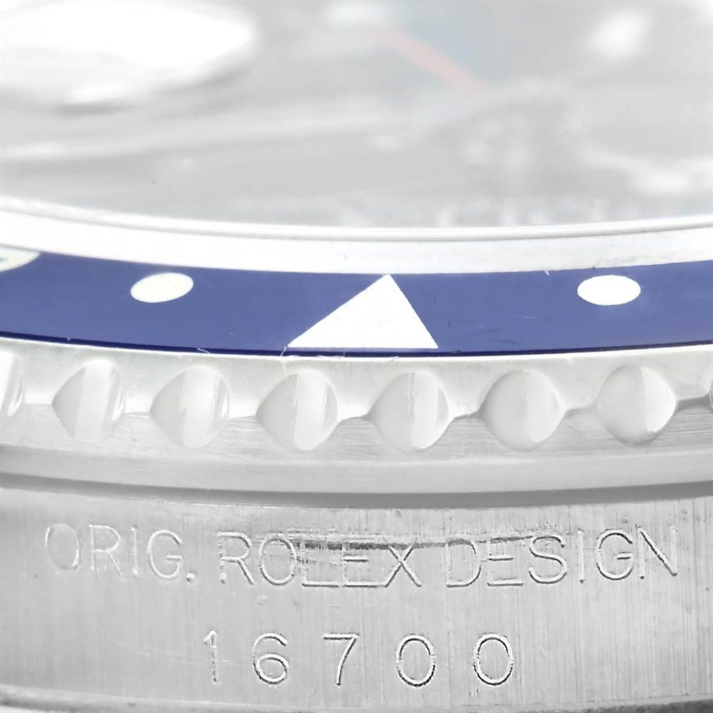 The image shows a close-up of the bezel and case of a Rolex GMT-Master 16700 Men's Stainless Steel Black Dial 16700 Men's Stainless Steel Black Dial model with the model number 16700 engraved.