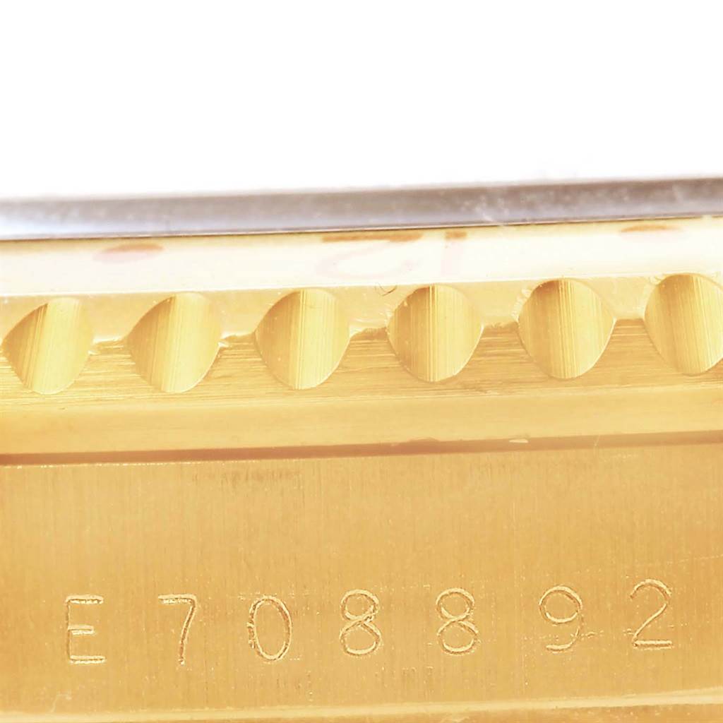 This close-up image shows the side view of the case with the serial number of a Rolex GMT-Master 16718 Men's Yellow Gold Brown Dial 16718 Men's Yellow Gold Brown Dial watch.