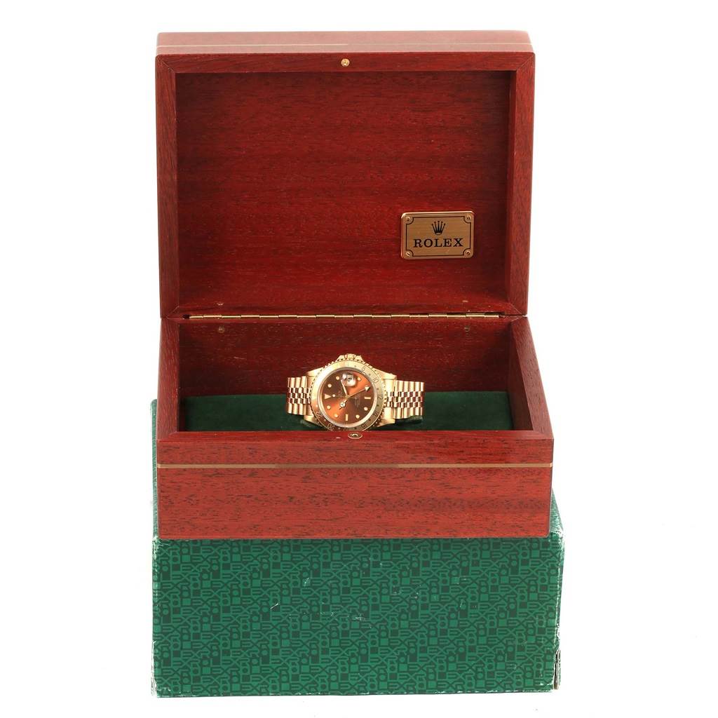 The image shows a Rolex GMT-Master 16718 Men's Yellow Gold Brown Dial 16718 Men's Yellow Gold Brown Dial watch in an open wooden box, angled slightly from the front.