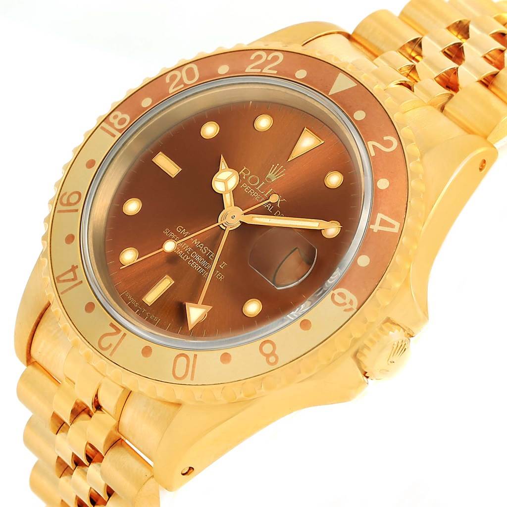 This image shows a Rolex GMT-Master 16718 Men's Yellow Gold Brown Dial 16718 Men's Yellow Gold Brown Dial watch from a slightly tilted angle, featuring the face, bezel, bracelet, and crown.