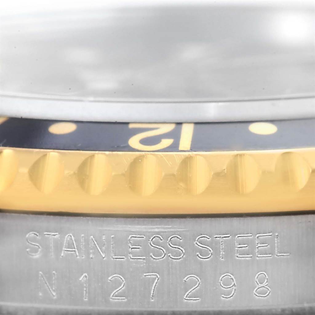 This is a close-up angle showing the bezel, crystal, and stainless steel casing with a serial number of the Rolex GMT-Master 16713 Men's Stainless Steel Black Dial 16713 Men's Stainless Steel Black Dial watch.