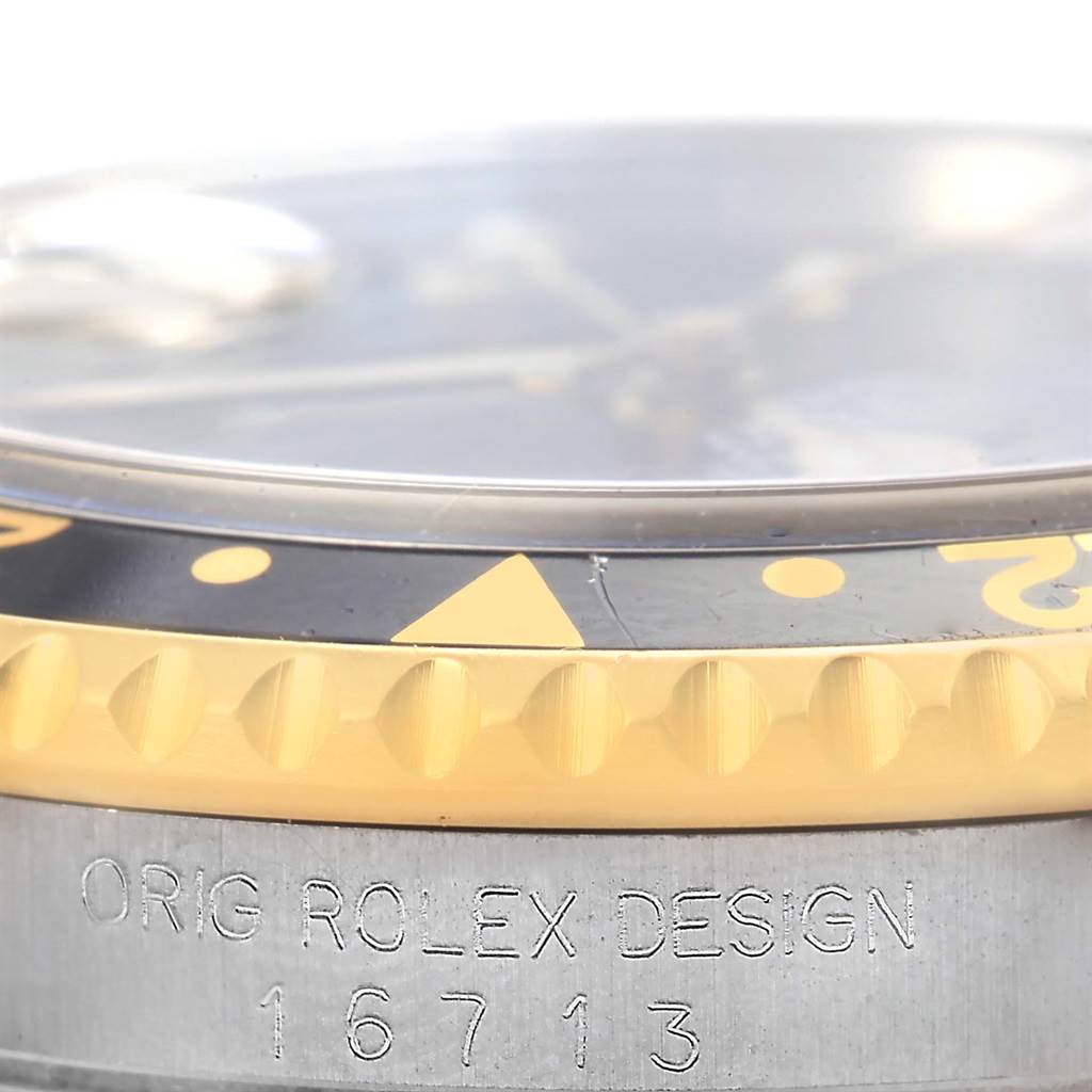 The close-up angle shows the bezel, crystal, and part of the case of a Rolex GMT-Master 16713 Men's Stainless Steel Black Dial 16713 Men's Stainless Steel Black Dial, with the model number 16713.