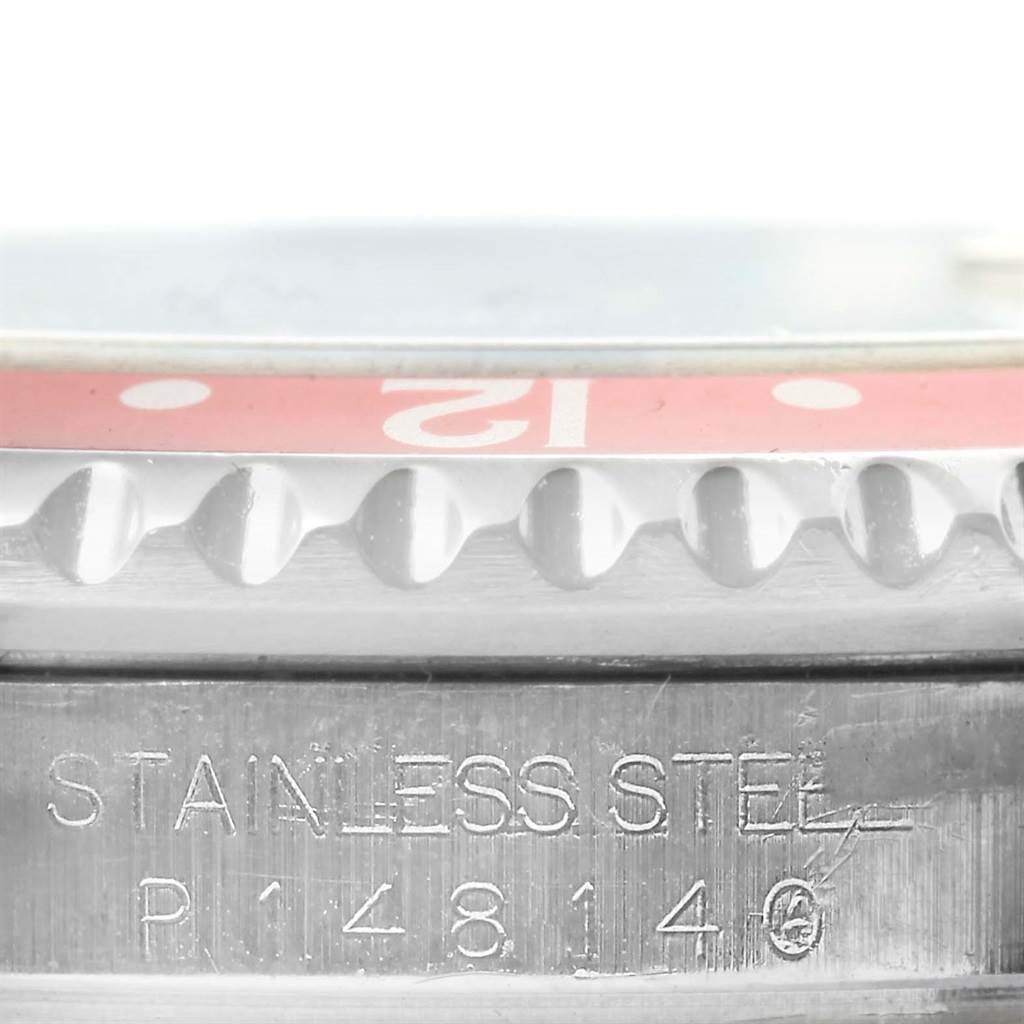 This close-up image shows the side view of the bezel and case of the Rolex GMT-Master 16710 Men's Stainless Steel Black Dial 16710 Men's Stainless Steel Black Dial watch, featuring its serial number engraving.