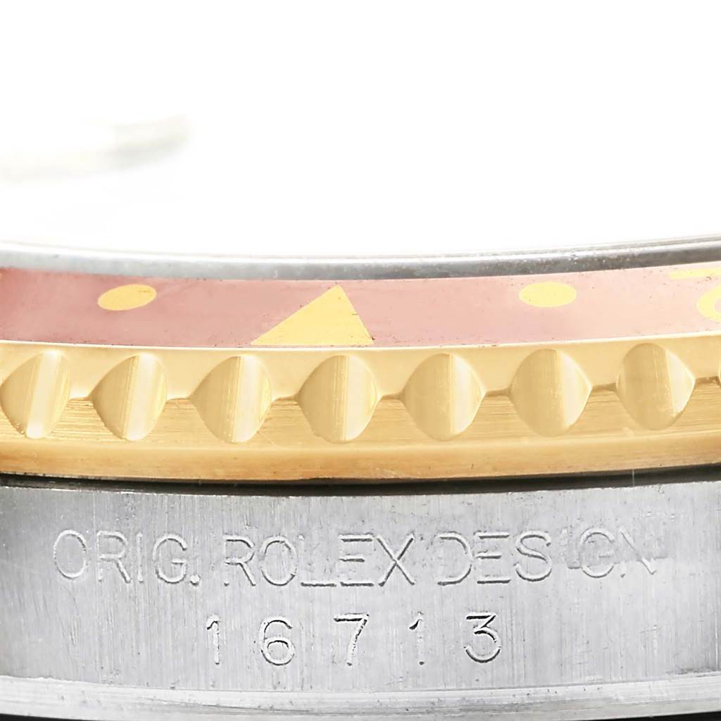 This image shows a close-up view of the bezel and case of a Rolex GMT-Master 16713 Men's Stainless Steel Grey Dial 16713 Men's Stainless Steel Grey Dial with the model number 16713 engraved.