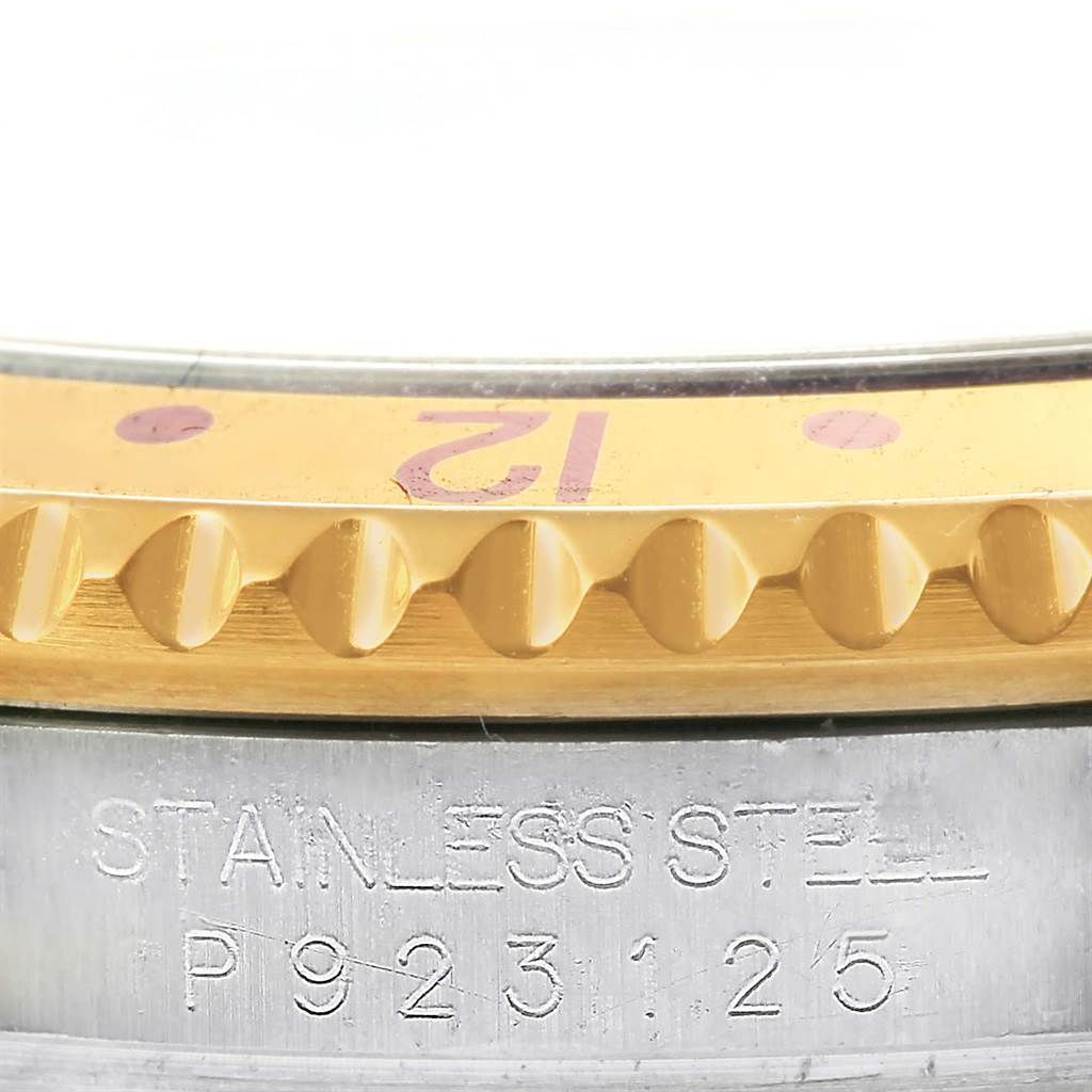 This image shows a close-up of the bezel and part of the stainless steel case of a Rolex GMT-Master 16713 Men's Stainless Steel Grey Dial 16713 Men's Stainless Steel Grey Dial watch.