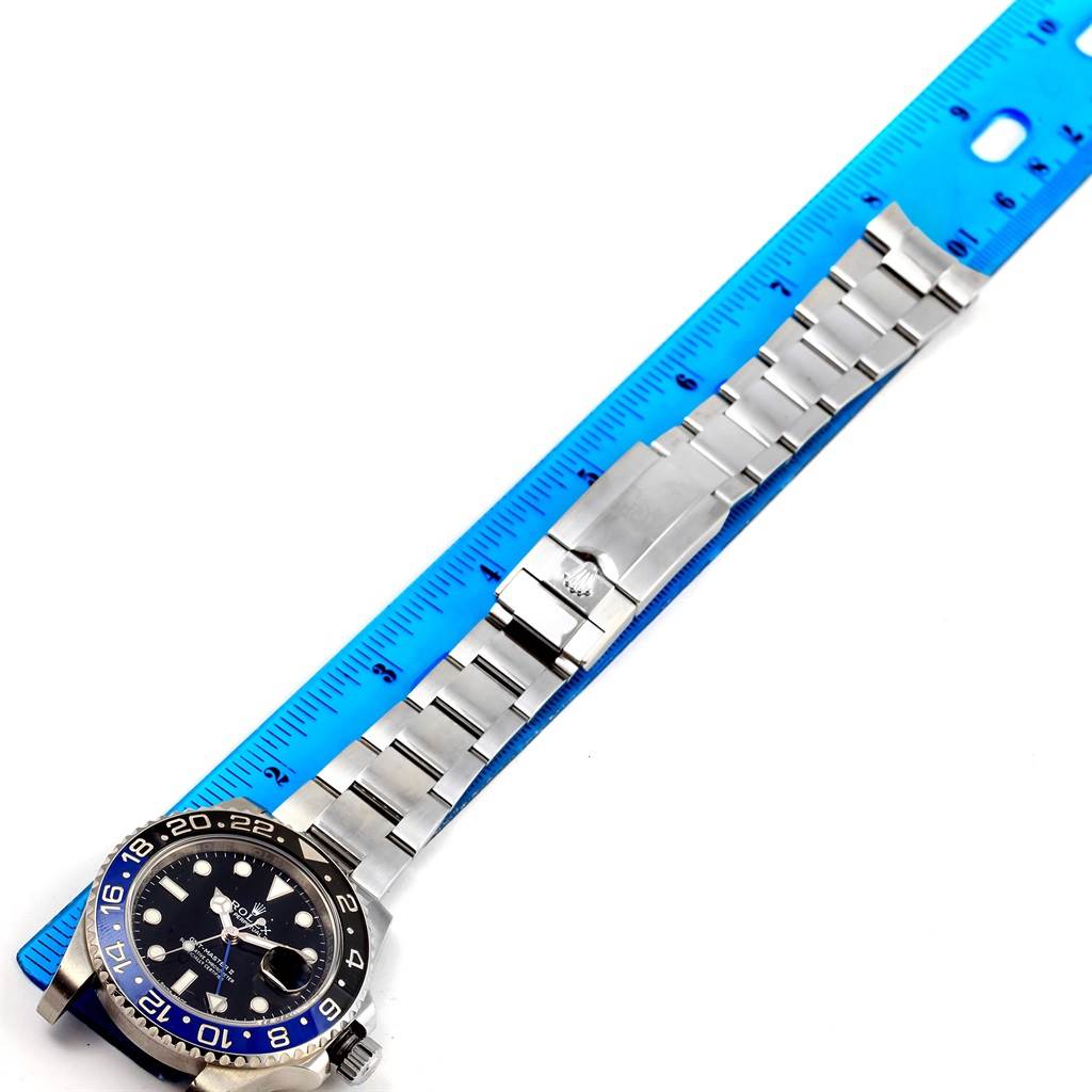 The image shows a Rolex GMT-Master 116710 Men's Stainless Steel Black Dial 116710 Men's Stainless Steel Black Dial watch laid flat next to a blue ruler, displaying the watch's face and bracelet.