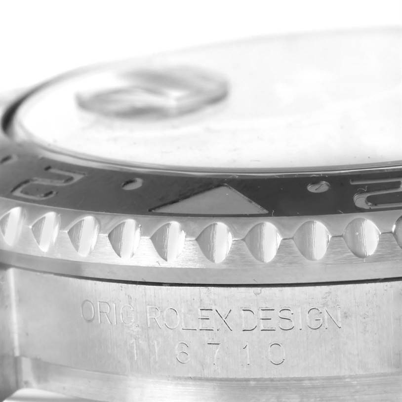 This close-up image of a Rolex GMT-Master 116710 Men's Stainless Steel Black Dial 116710 Men's Stainless Steel Black Dial shows the bezel and part of the case with the model number 16710 engraved.