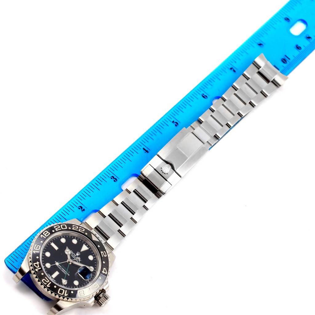 The image shows a Rolex GMT-Master 116710 Men's Stainless Steel Black Dial 116710 Men's Stainless Steel Black Dial watch laid flat horizontally, with a blue ruler used for measurement.
