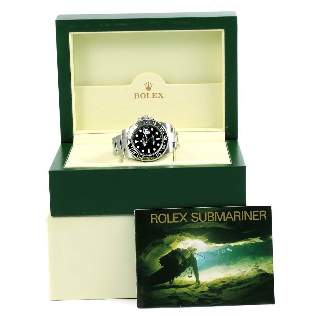The image shows a Rolex GMT-Master 116710 Men's Stainless Steel Black Dial 116710 Men's Stainless Steel Black Dial watch in its green box, with a Rolex Submariner booklet beside it.