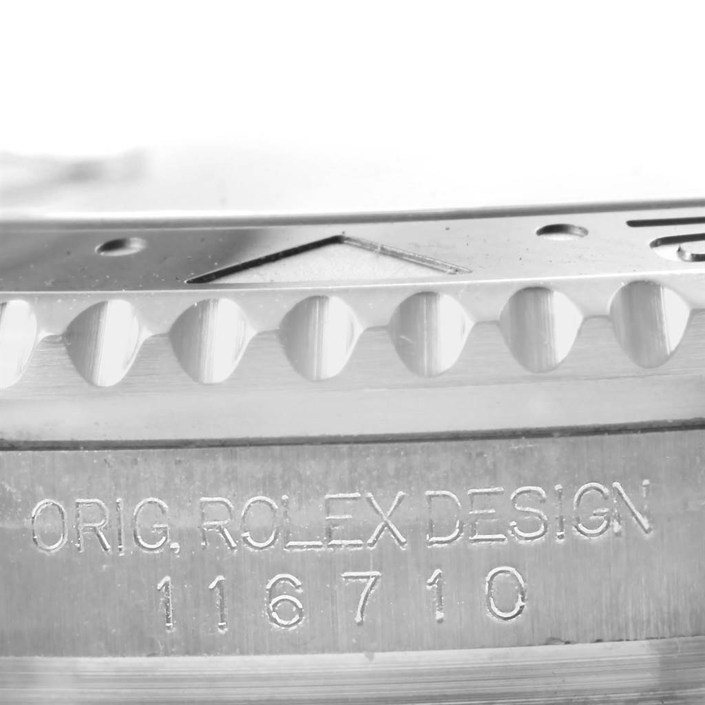 This image shows a close-up of the bezel and part of the case with the engraved model number of a Rolex GMT-Master 116710 Men's Stainless Steel Black Dial 116710 Men's Stainless Steel Black Dial.