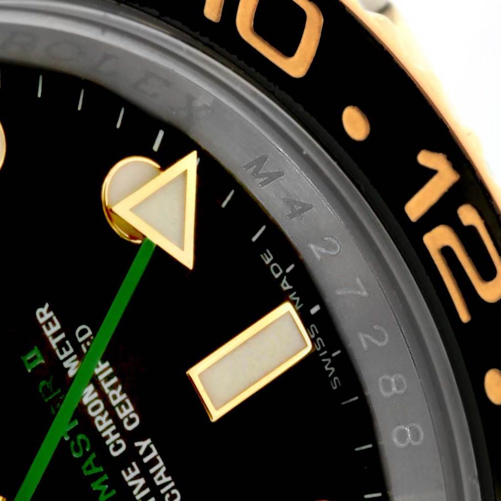 Close-up of the Rolex GMT-Master 116713 Men
s Stainless Steel Black Dial 116713 Men
s Stainless Steel Black Dial II watch showing part of the dial, bezel, and markers at an angled view.