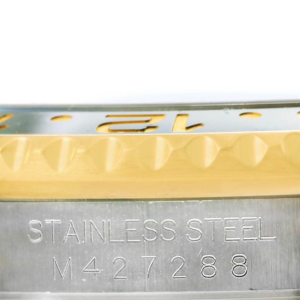 The image shows a close-up of the stainless steel case and the edge of the bezel with markings for a Rolex GMT-Master 116713 Men
s Stainless Steel Black Dial 116713 Men
s Stainless Steel Black Dial watch.