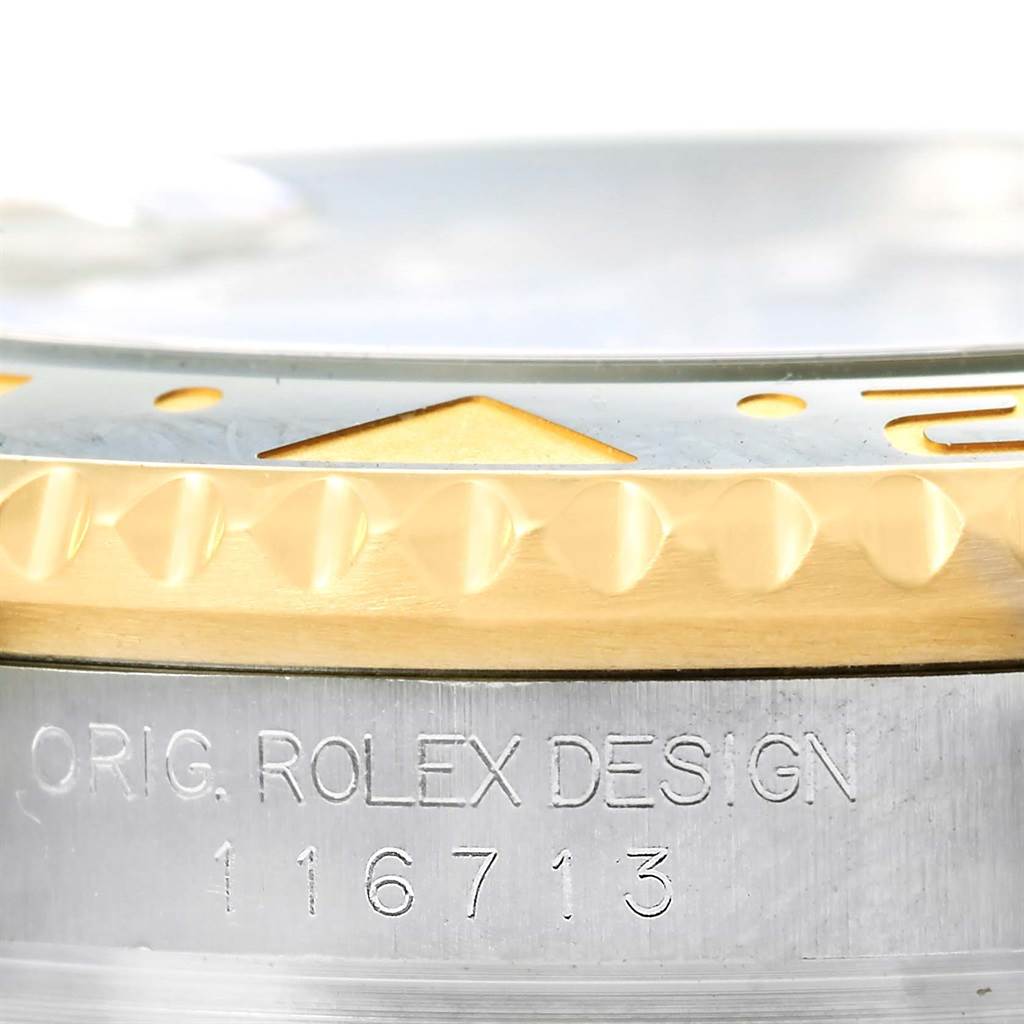 The image shows a close-up of the bezel and serial engraving of a Rolex GMT-Master 116713 Men
s Stainless Steel Black Dial 116713 Men
s Stainless Steel Black Dial watch.