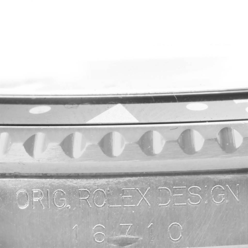 The image shows a close-up of the bezel and case edge of a Rolex GMT-Master 16710 Men's Stainless Steel Black Dial 16710 Men's Stainless Steel Black Dial watch, model number 16710.