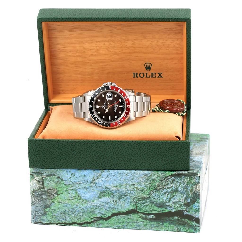 The Rolex GMT-Master 16710 Men's Stainless Steel Black Dial 16710 Men's Stainless Steel Black Dial watch is shown at a frontal angle, displayed inside its open box.
