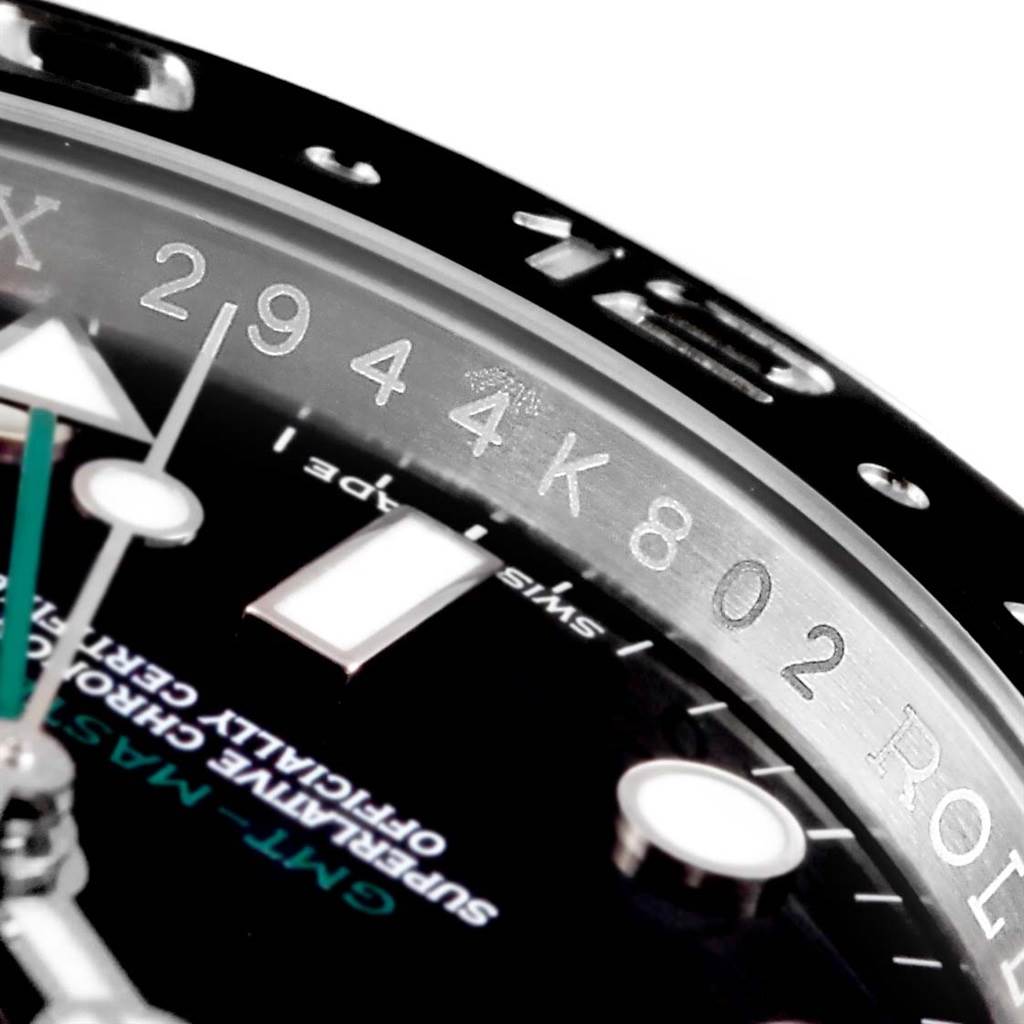 The image shows a close-up of the dial, bezel, and part of the inscription on a Rolex GMT-Master 116710 Men's Stainless Steel Black Dial 116710 Men's Stainless Steel Black Dial watch.