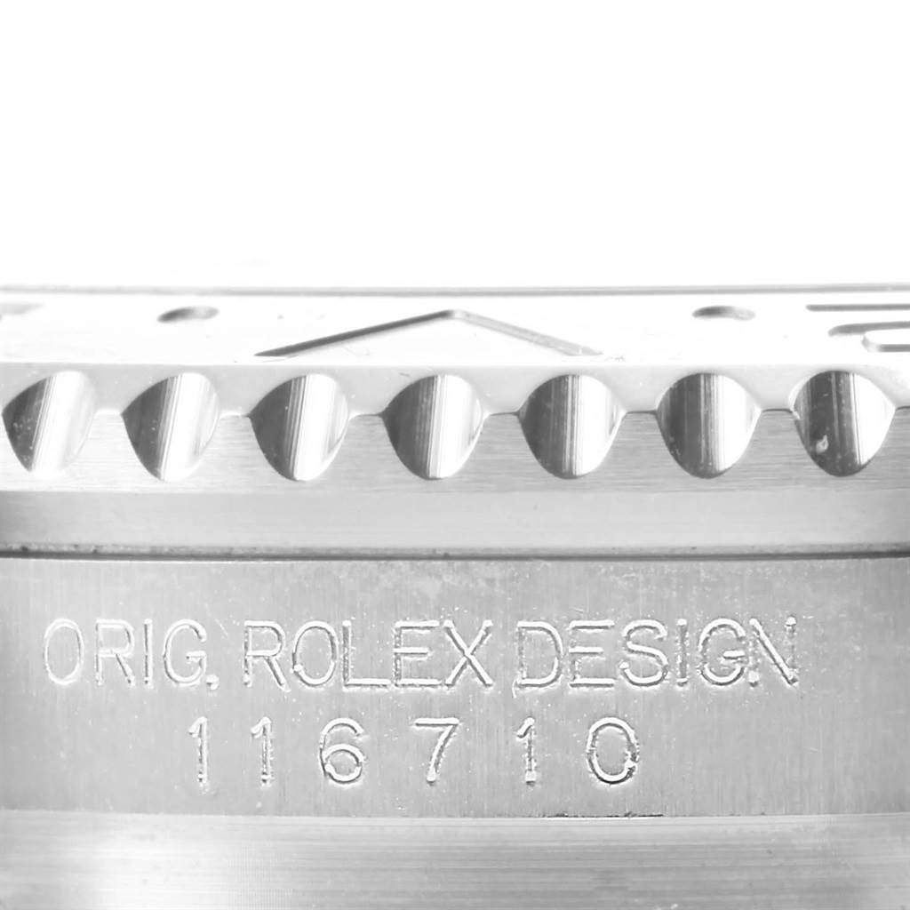 This image shows a close-up of the model reference number engraving and part of the bezel of a Rolex GMT-Master 116710 Men's Stainless Steel Black Dial 116710 Men's Stainless Steel Black Dial watch.