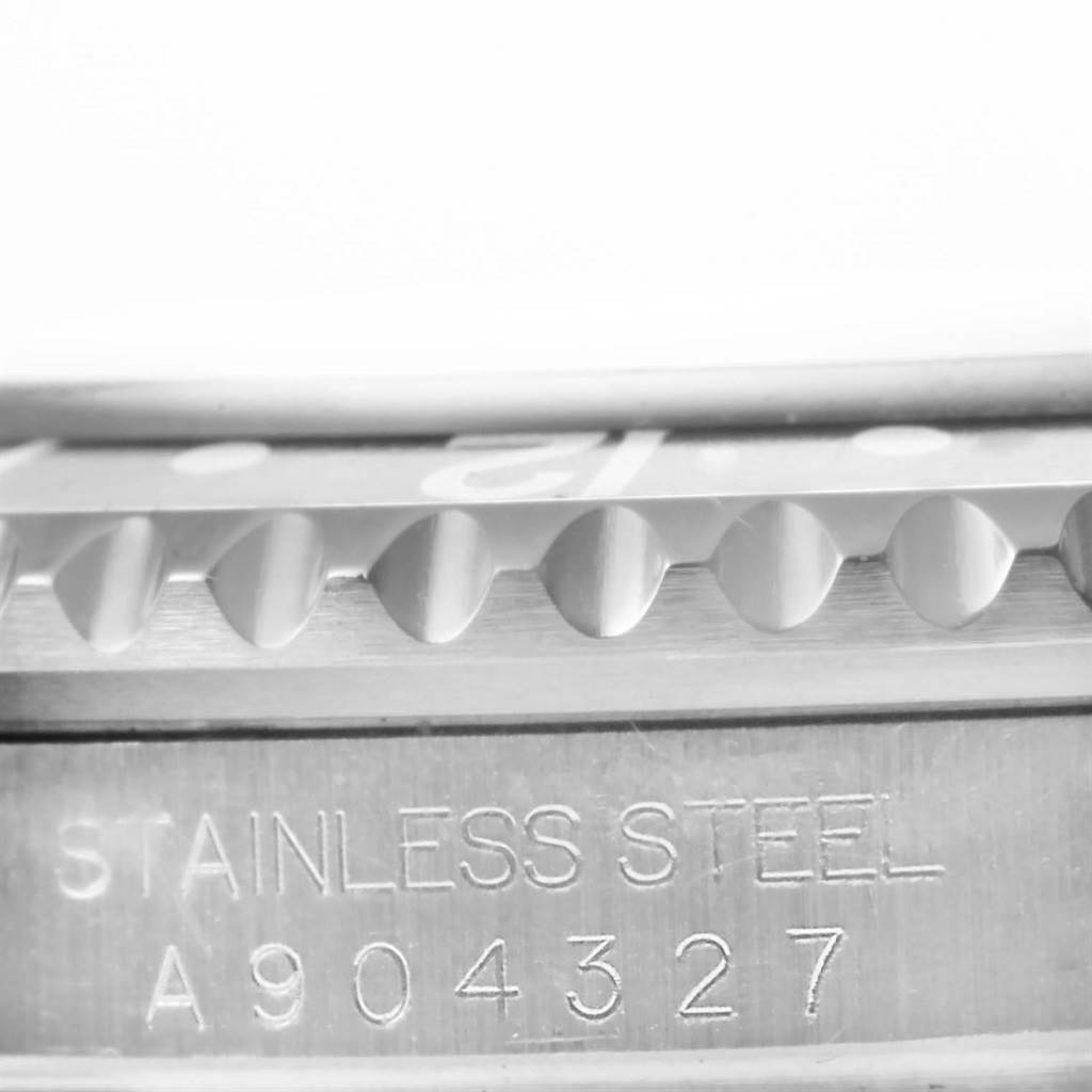 This image shows a close-up angle of the Rolex GMT-Master 16710 Men's Stainless Steel Black Dial 16710 Men's Stainless Steel Black Dial's stainless steel bezel and serial number.