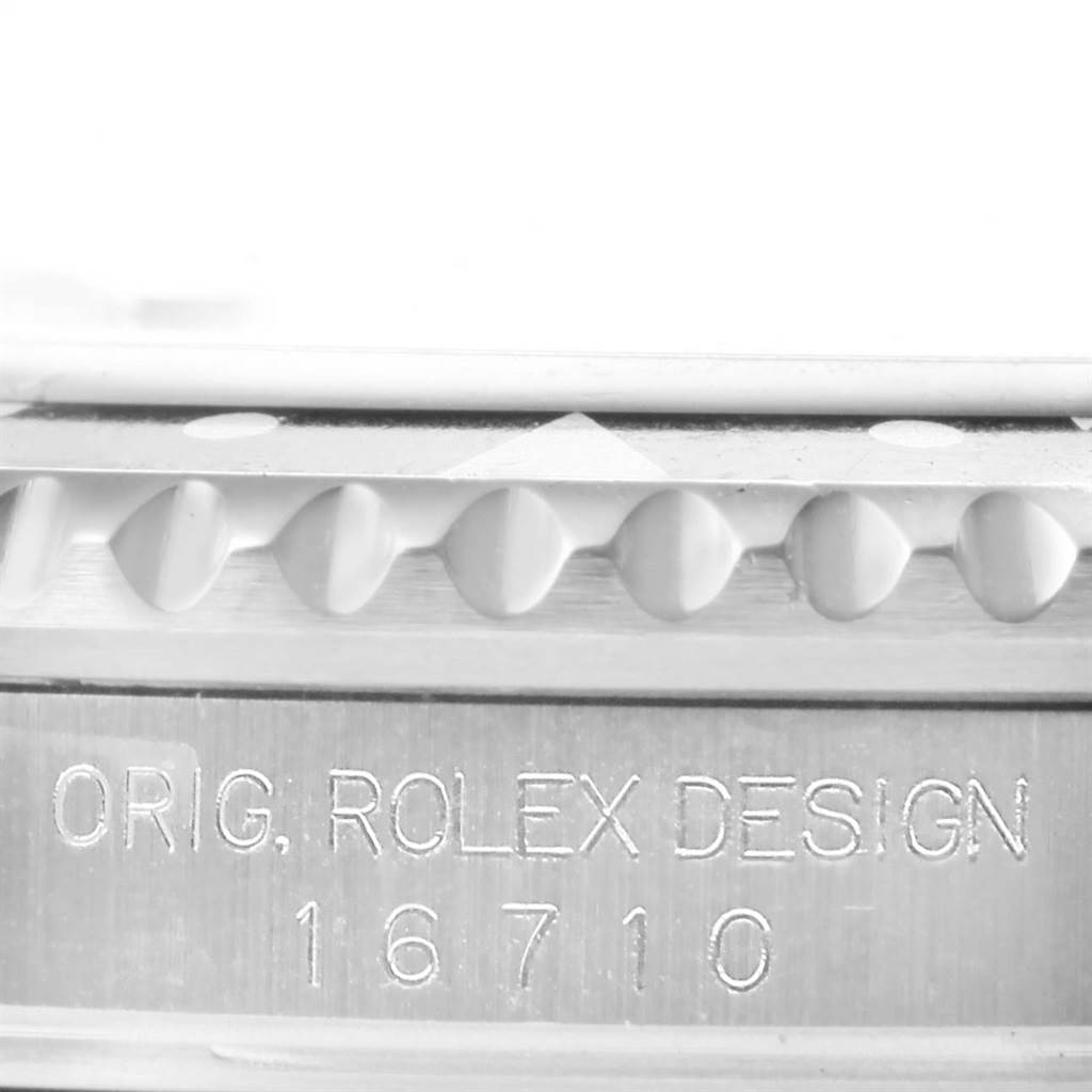 This image shows the side view of the bezel and engraving on a Rolex GMT-Master 16710 Men's Stainless Steel Black Dial 16710 Men's Stainless Steel Black Dial model 16710.