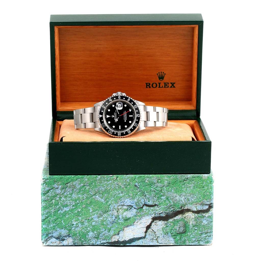 The Rolex GMT-Master 16710 Men's Stainless Steel Black Dial 16710 Men's Stainless Steel Black Dial watch is shown at a front angle, placed inside its branded box on a cushioned display.