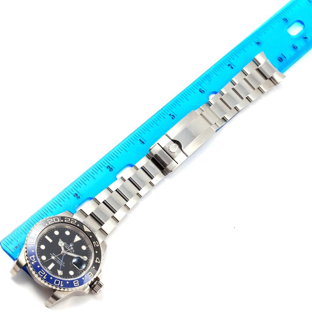 The Rolex GMT-Master 116710 Men
s Stainless Steel Black Dial 116710 Men
s Stainless Steel Black Dial watch is shown from a top-down angle with a blue ruler indicating its length.