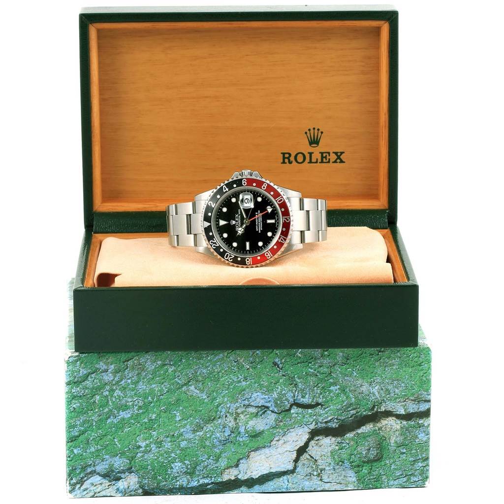 The Rolex GMT-Master 16710 Men
s Stainless Steel Black Dial 16710 Men
s Stainless Steel Black Dial watch is shown from the front in an open display box, highlighting its face and metal bracelet.