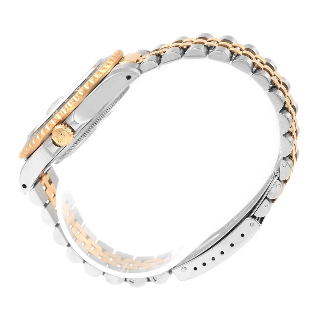 This side angle shot of the Rolex GMT-Master 16713 Men's Stainless Steel Black Dial 16713 Men's Stainless Steel Black Dial shows the case, crown, and two-tone bracelet.