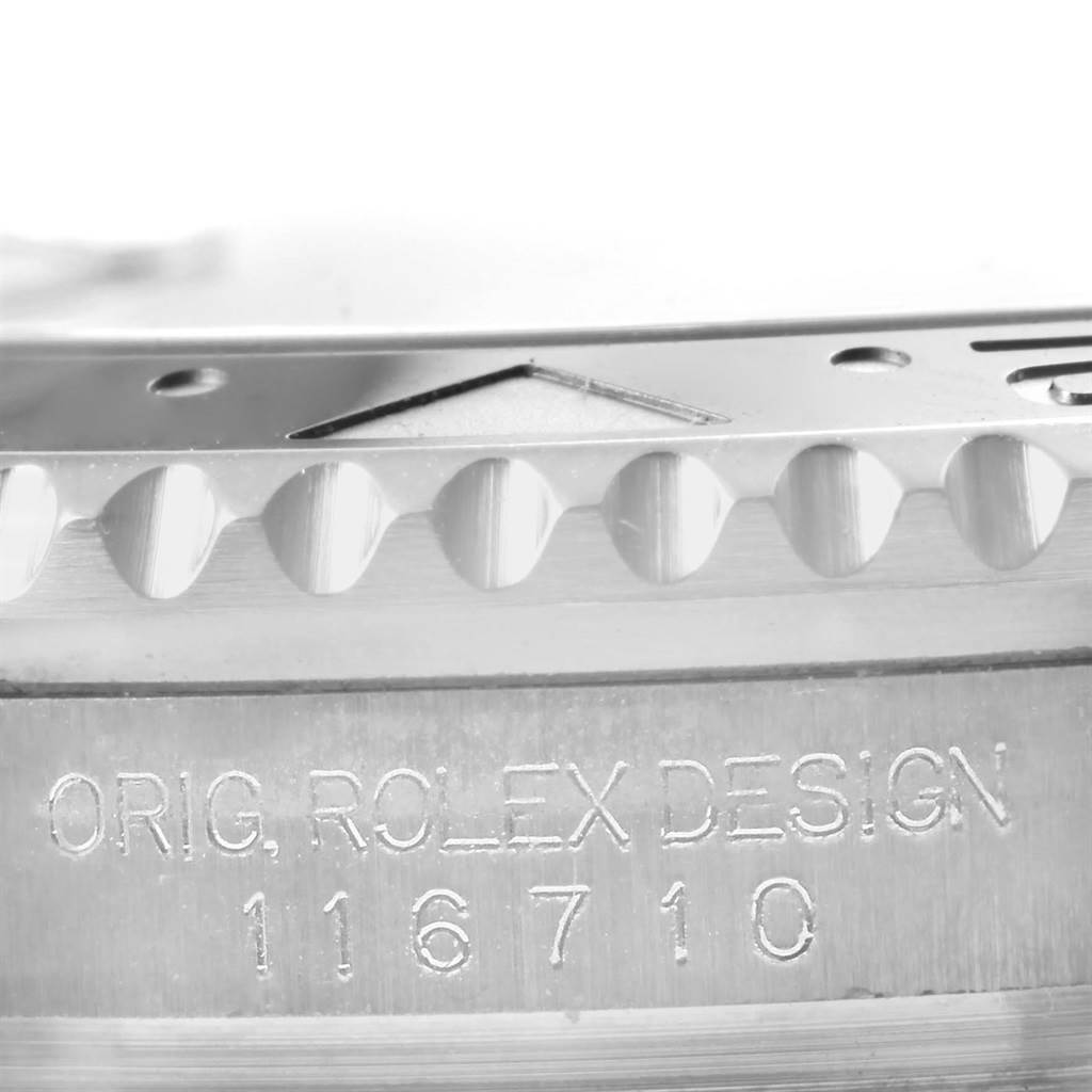 The image shows a close-up of the side of a Rolex GMT-Master 116710 Men
s Stainless Steel Black Dial 116710 Men
s Stainless Steel Black Dial watch, focusing on the model number 116710 and bezel edge.