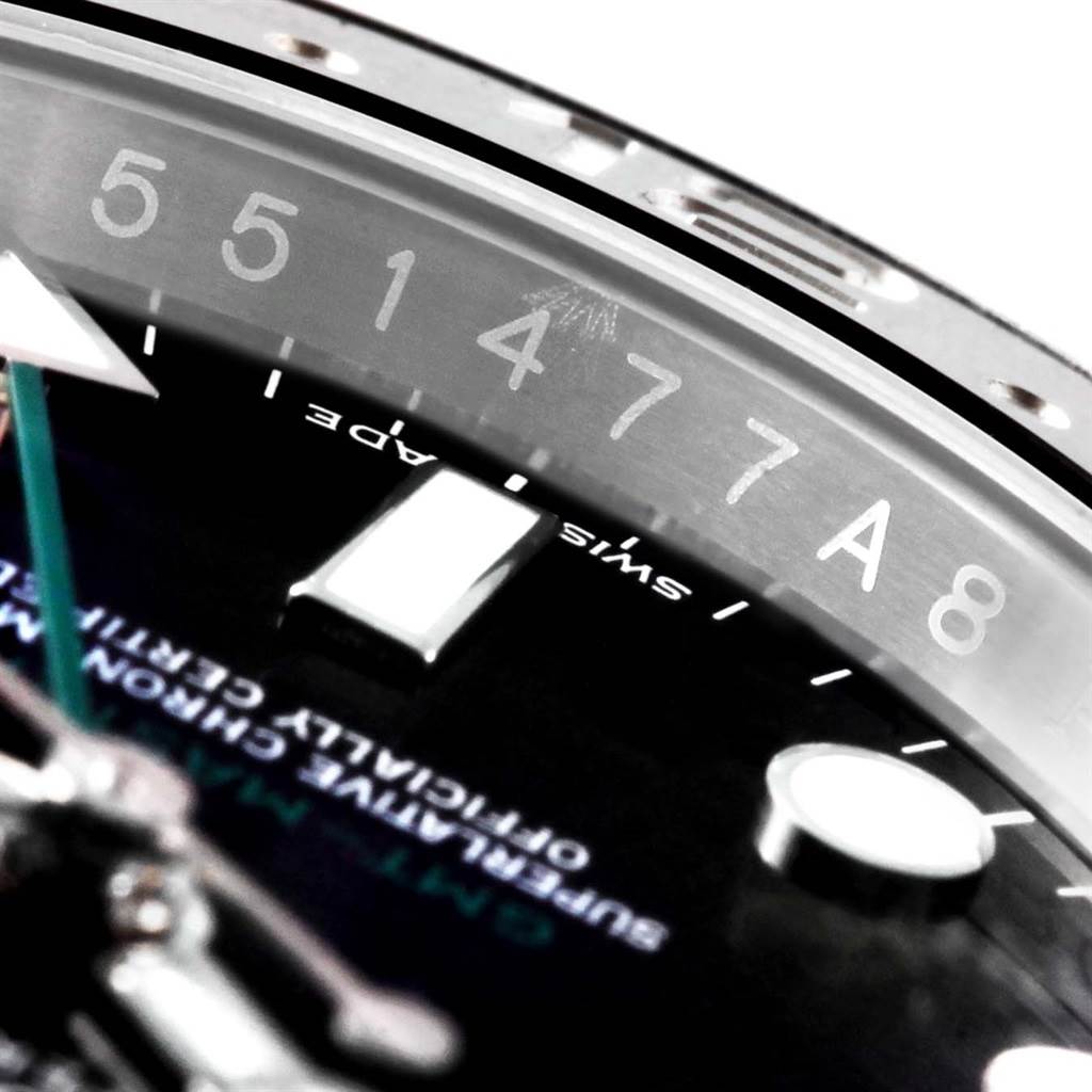 This close-up shot of the Rolex GMT-Master 116710 Men
s Stainless Steel Black Dial 116710 Men
s Stainless Steel Black Dial watch shows part of the dial, bezel, and reference numbers engraved on the inner ring.