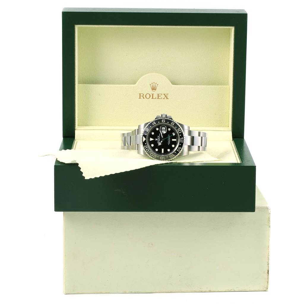 The Rolex GMT-Master 116710 Men
s Stainless Steel Black Dial 116710 Men
s Stainless Steel Black Dial watch is shown front-facing in an open, green and cream box.