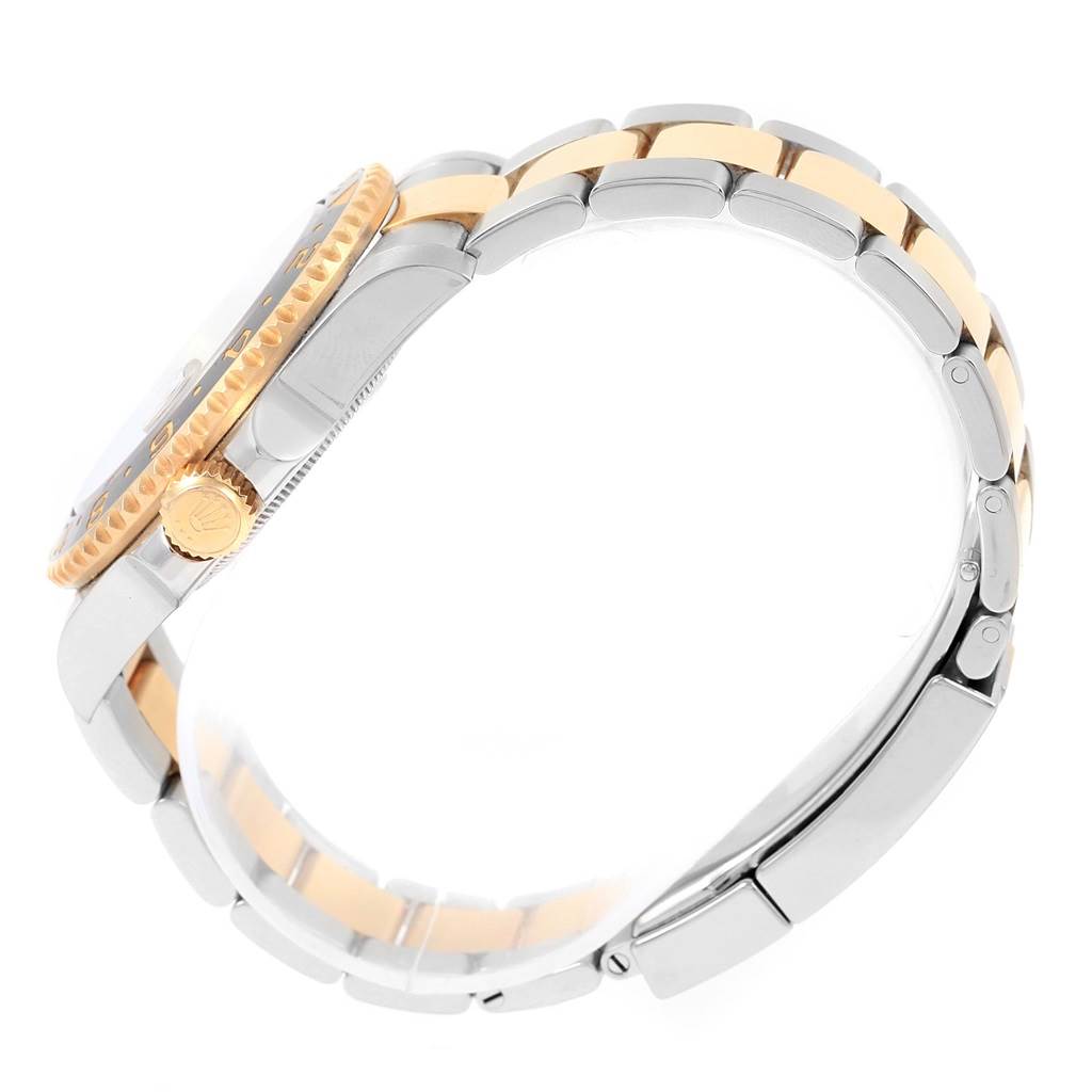 The image shows a side profile of a Rolex GMT-Master 116713 Men's Stainless Steel Black Dial 116713 Men's Stainless Steel Black Dial, highlighting its bezel, crown, and two-tone bracelet.