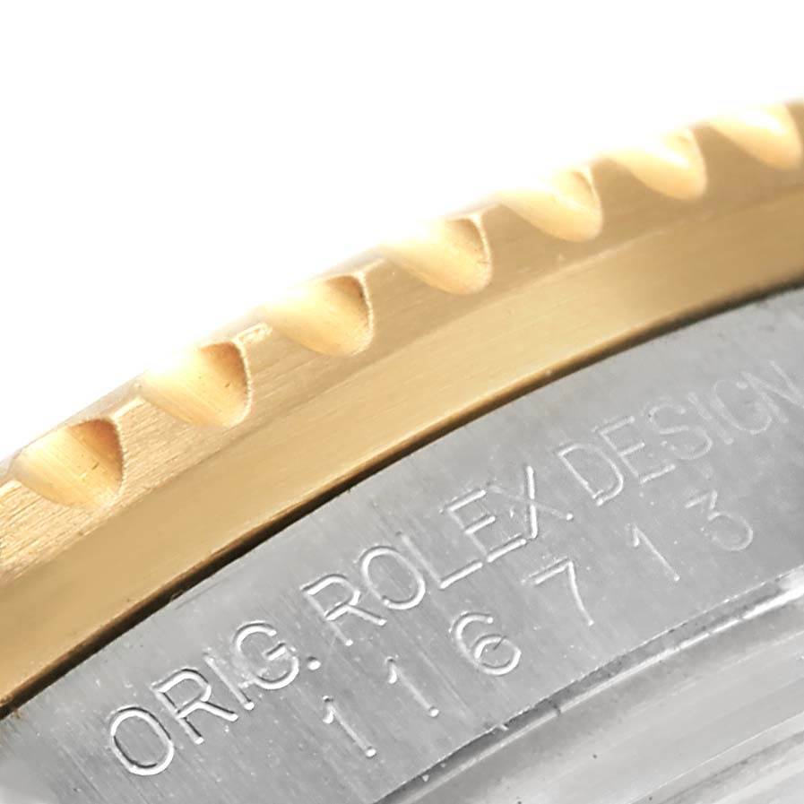 This is a close-up image of the bezel edge and the engraving on the case back of a Rolex GMT-Master 116713 Men's Stainless Steel Black Dial 116713 Men's Stainless Steel Black Dial watch.