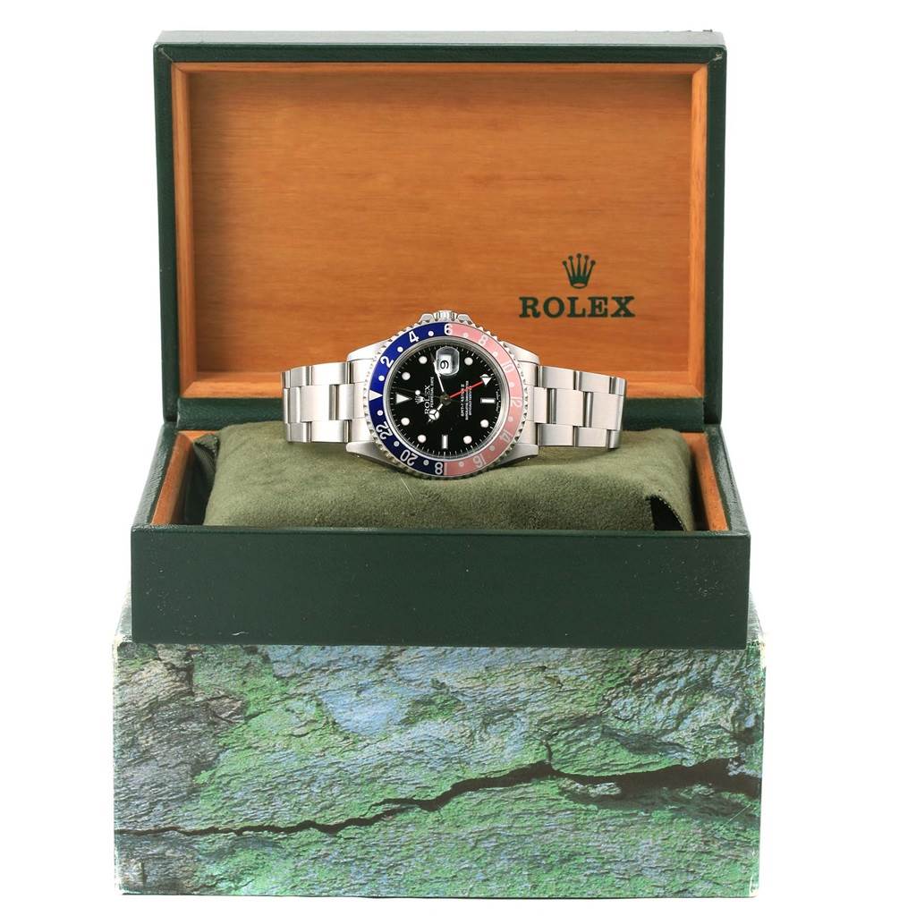 The Rolex GMT-Master 16710 Men's Stainless Steel Black Dial 16710 Men's Stainless Steel Black Dial watch is shown in an open box, displaying the face, bezel, and bracelet.