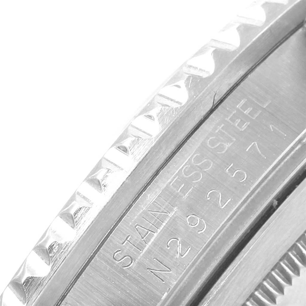 This image shows a close-up of the bezel and serial number engraving on the stainless steel case of a Rolex GMT-Master 16710 Men's Stainless Steel Black Dial 16710 Men's Stainless Steel Black Dial watch.
