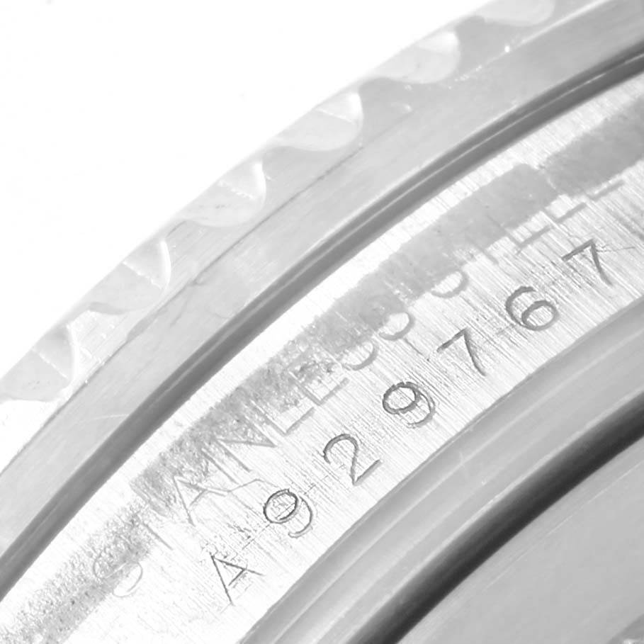 This close-up angle shows the serial number engraving on the caseback rim of a Rolex GMT-Master 16710 Men's Stainless Steel Black Dial 16710 Men's Stainless Steel Black Dial watch.