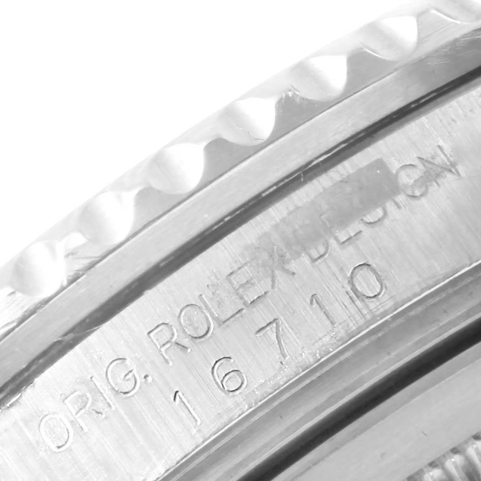This photo shows a close-up of the engraved bezel and serial number of the Rolex GMT-Master 16710 Men's Stainless Steel Black Dial 16710 Men's Stainless Steel Black Dial watch.