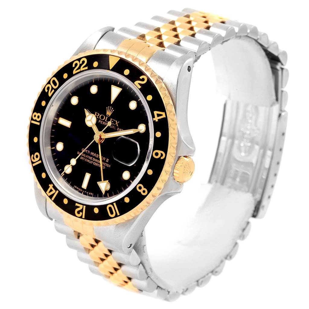 This Rolex GMT-Master 16713 Men's Stainless Steel Black Dial 16713 Men's Stainless Steel Black Dial watch is shown in a three-quarter view, highlighting its bezel, dial, crown, and two-tone bracelet.